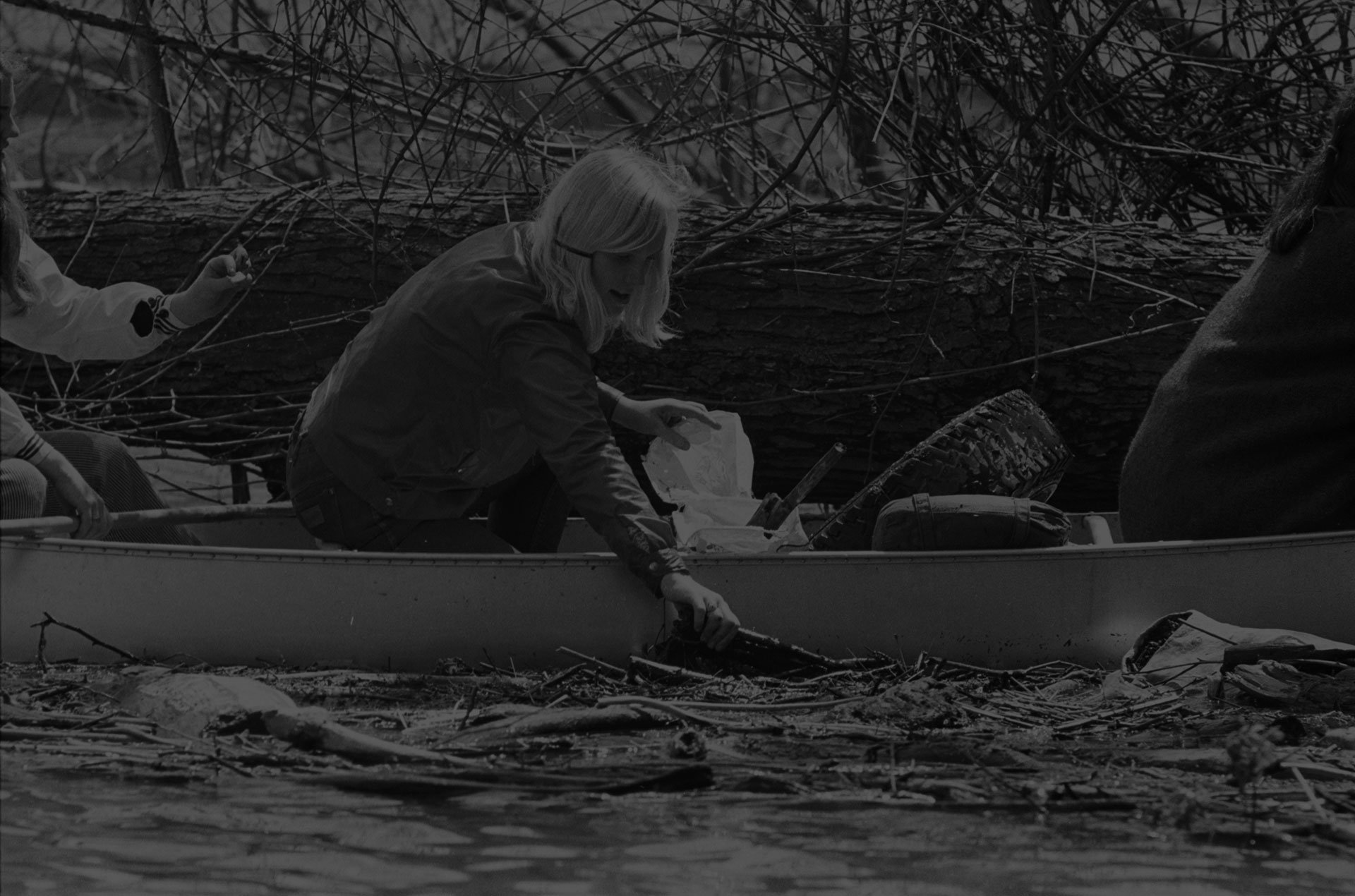 Girl Scout in canoe, picking trash out of the Potomac River during Earth Week