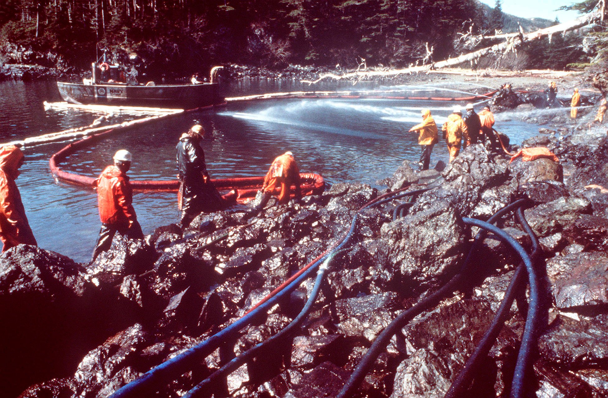 On March 28,1989, workers steam-blasted rocks and washed down Alaskan shorelines soaked in crude oil from the leaking tanker Exxon Valdez, which ran aground on Bligh Reef in Prince William Sound, Alaska, on March 23, 1989. It spilled 11 million gallons of crude oil, which resulted in the largest oil spill in U.S. history until the Deepwater Horizon disaster in 2010.