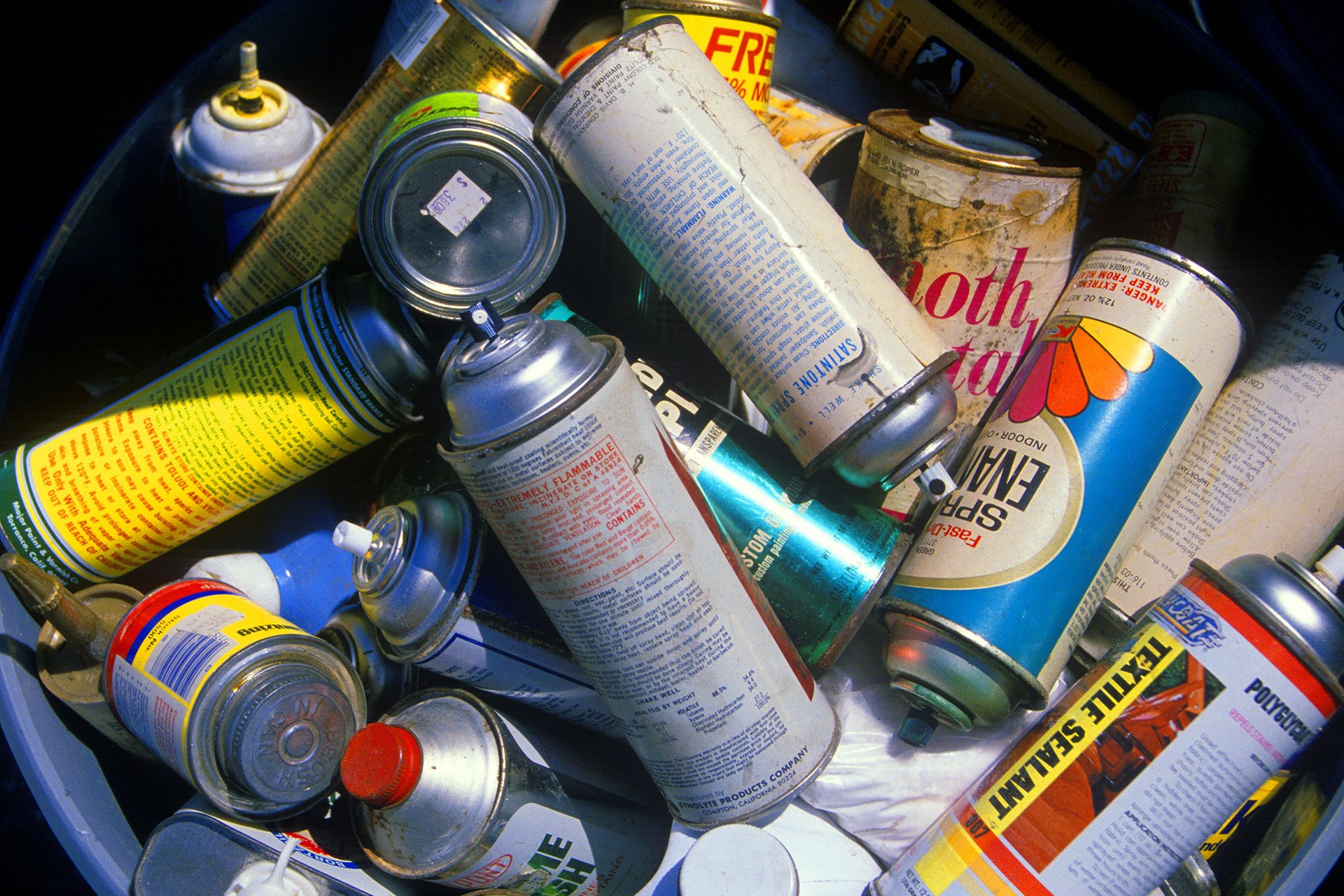 A pile of discarded aerosol cans.