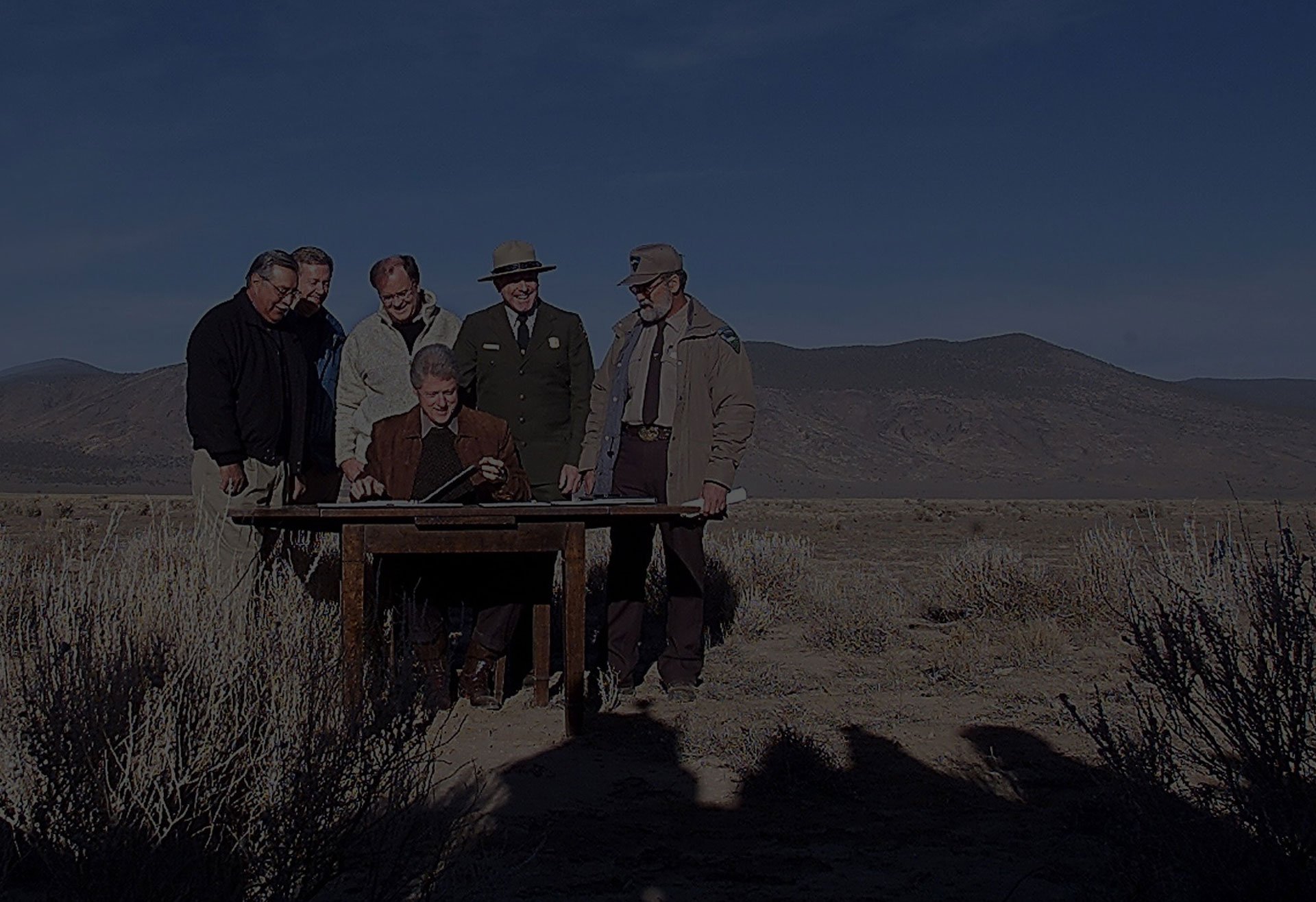 President Bill Clinton prepared to sign proclamations creating three new national monuments to protect scenic lands in Arizona's Grand Canyon in 2000. He was joined by (from left) Congressman Ed Pastor, U.S. Interior Secretary Bruce Babbitt, Congressman Sam Farr, Lake Mead National Recreation Area superintendent Alan O'Neil, and field manager of the Bureau of Land Management Roger Taylor.