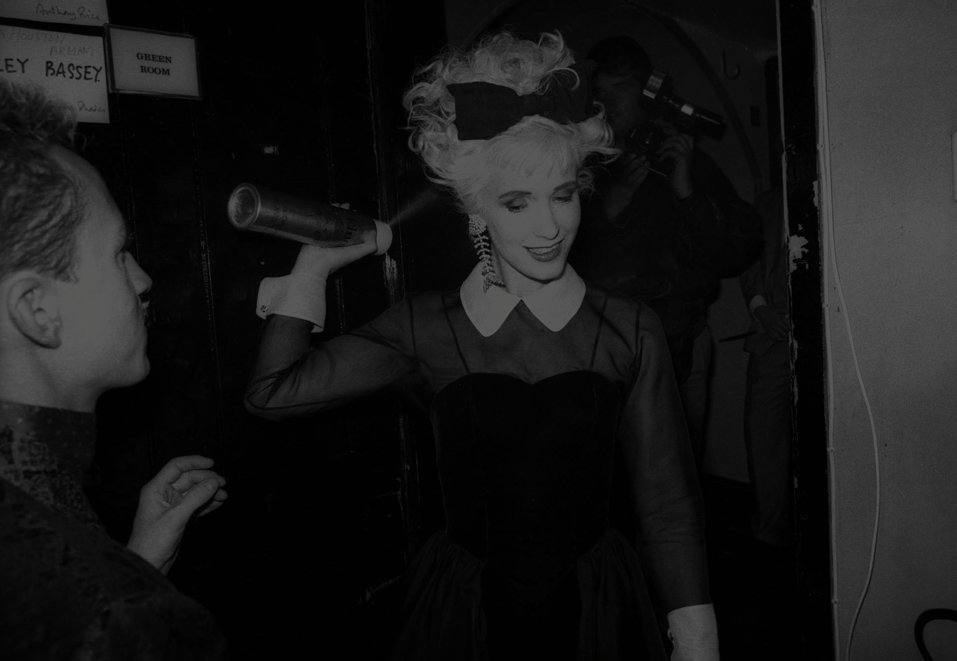 Paula Yates sprays her hair with hairspray during Fashion Aid at the Royal Albert Hall on November 5th, 1985.